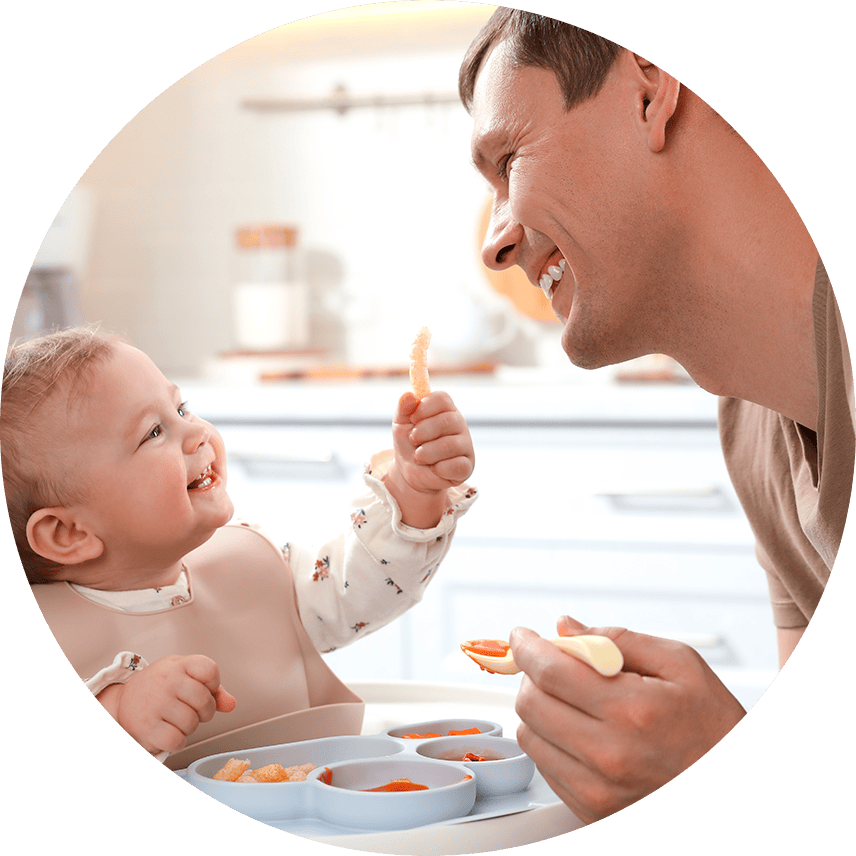 Baby eating with dad